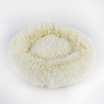 Round shaggy pet sleep bed in cream, with padded rim and inner lounging nest