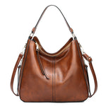Brown hobo bucket bag with dual straps, side zipper pockets and tassel pulls
