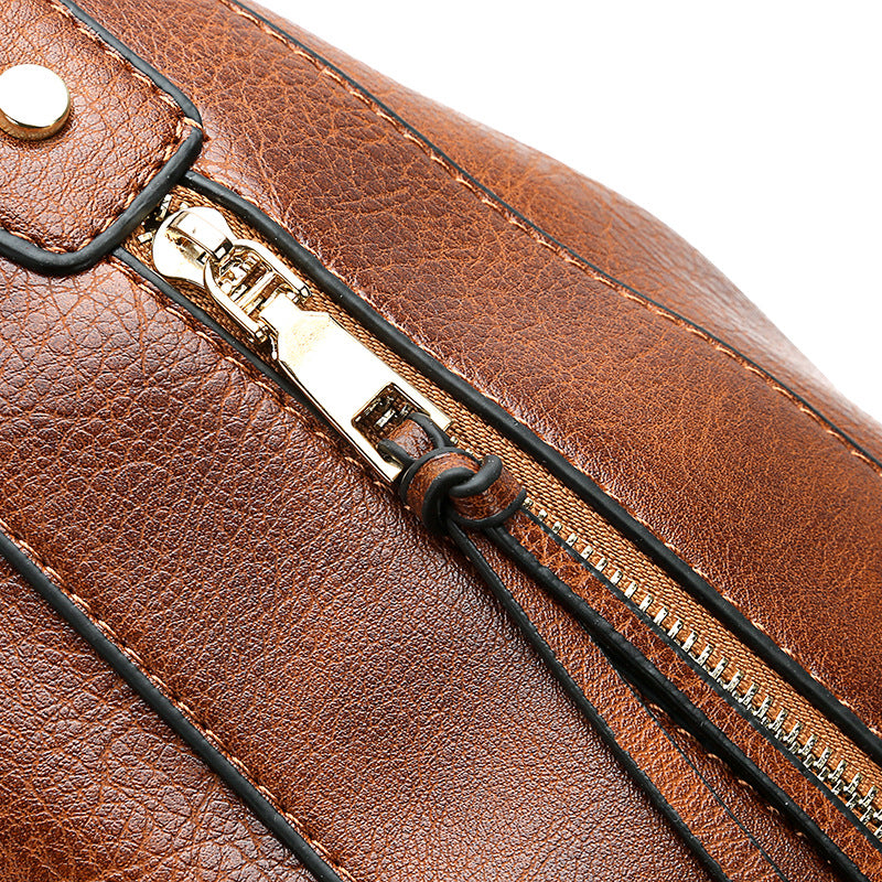 Brown hobo bucket bag close-up of zipper track and metal pull tab