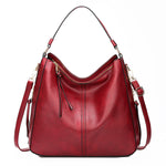 Red hobo bucket bag with zipper top, side pockets and shoulder straps