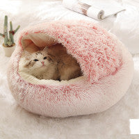 Round plush pet bed in pink, with a cat resting inside