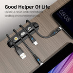 Black magnetic cable organizer clips holding multiple USB cable ends on desk