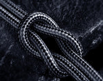 Braided cable close-up with textured black and gray weave