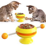 Rotatable cat training toy with yellow and orange base, amber dome, spring track and ball