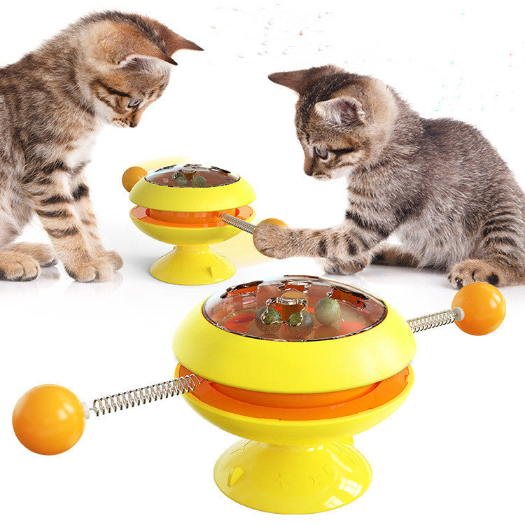 Rotatable cat training toy with yellow base, amber dome, spring ball track and ball