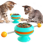 Rotatable cat training toy with teal base, amber dome, spring track and ball