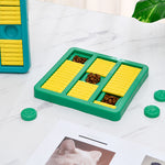 Green slow-feeding dog toy with yellow ridged sections and teal paw-shaped lid pieces