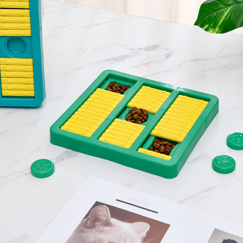 Green slow-feeding dog toy with yellow ridged sections and teal paw-shaped lid pieces