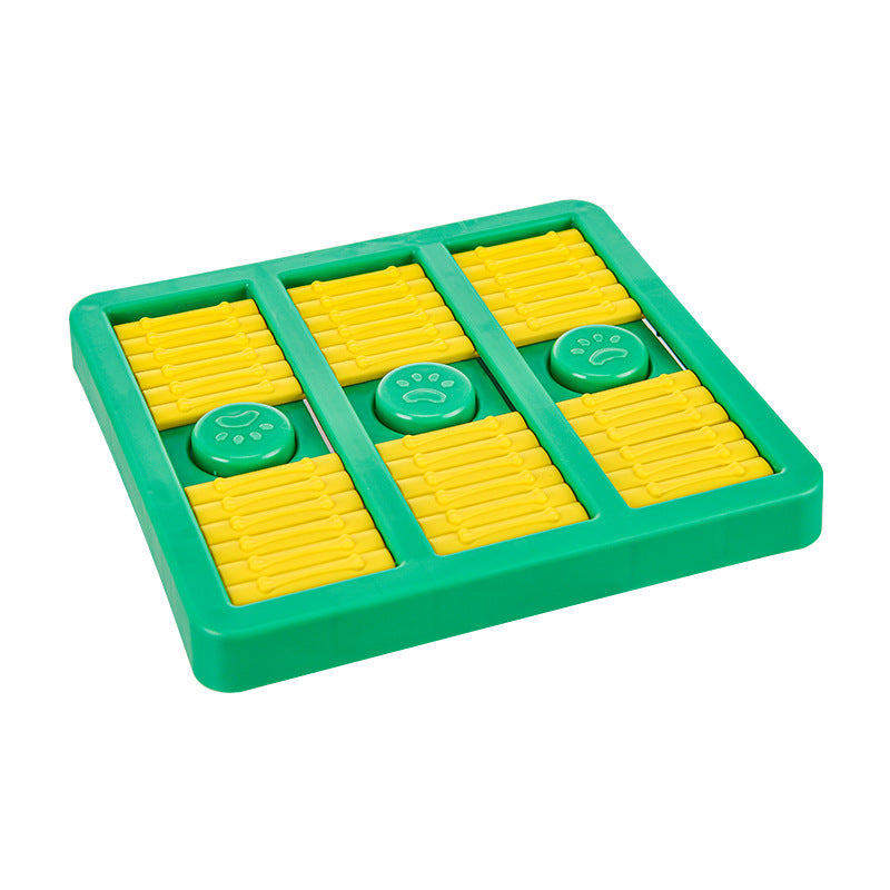 Green slow-feeding dog toy with yellow ridged compartments and paw print button lids