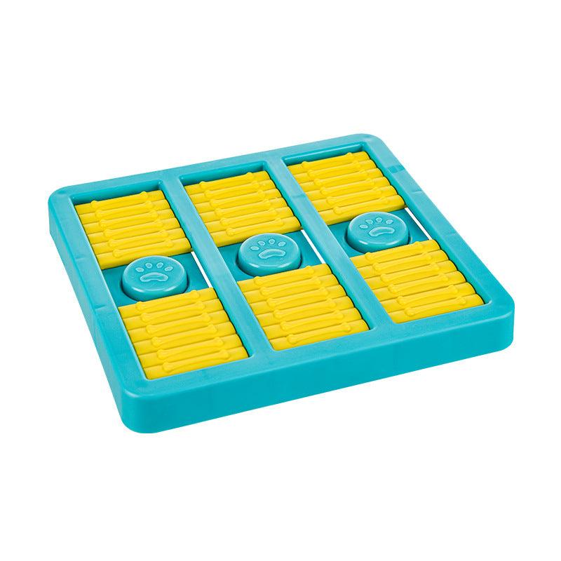 Teal slow-feeding dog toy with yellow ridged compartments and paw print button inserts