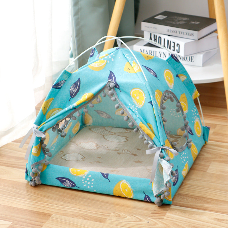 Enclosed cat tent bed, blue fabric with sea-themed print, gray pom trim and tie door