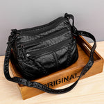 Black soft PU leather messenger bag with three zip compartments and adjustable crossbody strap