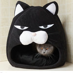 Black cat-face pet bed nest with hood opening and plush cushioned interior