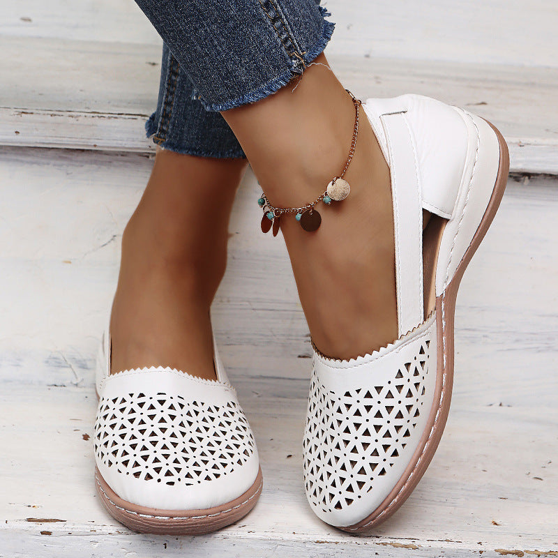 White round-toe wedge sandals with laser-cut upper and cushioned heel cup