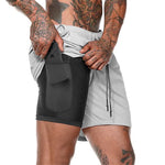 Men's light gray two-layer compression shorts with black front pouch pocket and drawstring waist