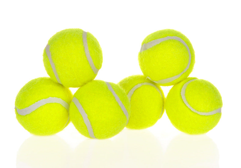 Neon yellow fuzzy tennis balls with white stripes, clustered in front of launcher