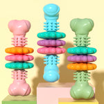 Assorted dog bone chew toys with raised nubs in pink, blue, and green