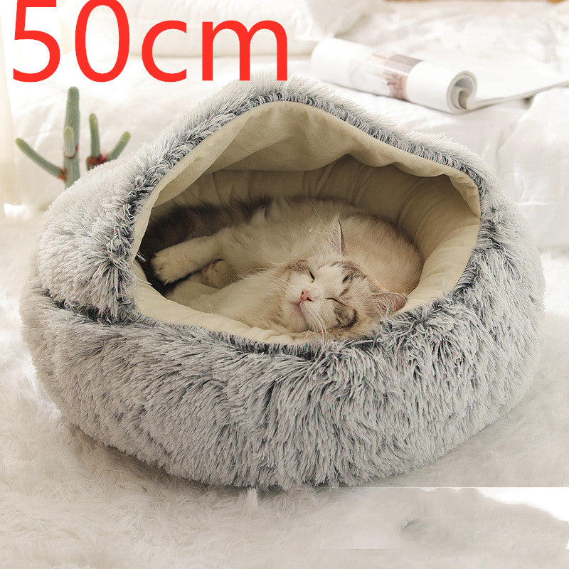 Grey round plush pet bed with shag rim and hooded cradle, cat sleeping inside.