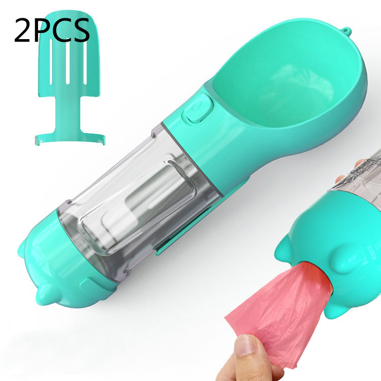 Teal portable pet water bottle feeder with transparent tube and pink waste bag holder
