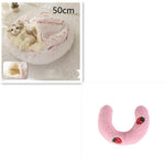 Half-moon plush bolster with pink fabric and strawberry patches