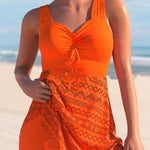 Orange one-piece swimsuit with ruched chest pad and lace-patterned skirt overlay