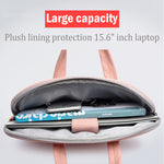Pink laptop bag with plush-lined interior holding a laptop and notebooks.