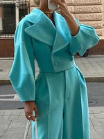 Teal short lapel jacket with long sleeves and matching high-waist trousers, front view