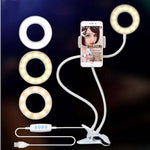 LED selfie ring light with multiple color rings, smartphone on clamp, dual cables