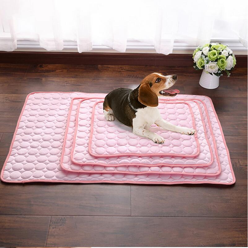 Pink cooling pad mat with pebble texture; beagle dog lying on top