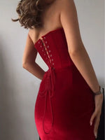 Red strapless midi dress with corset-style lacing detail and fitted sweetheart bodice