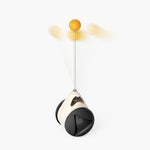 Hanging cat rotating windmill toy with black base and orange ball on string