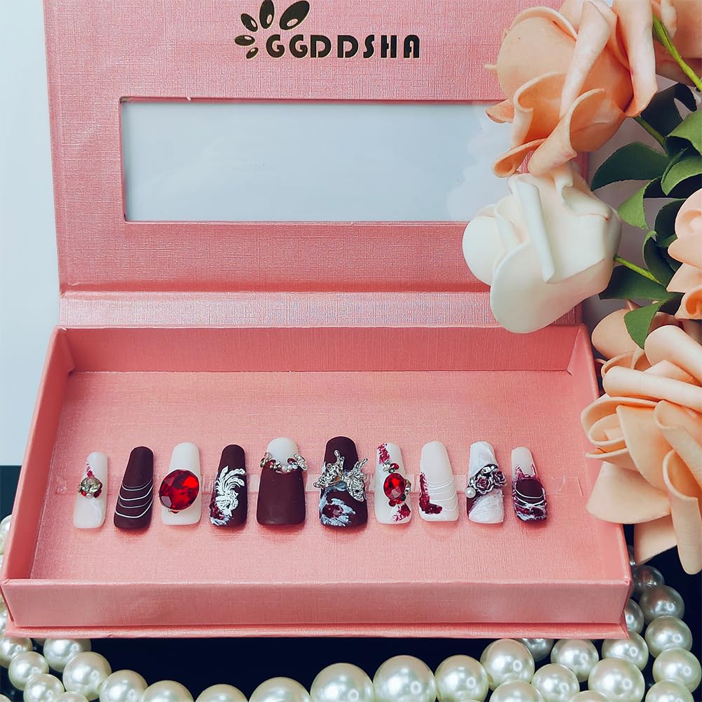 Shiny press-on long nails set with red, white, and dark purple accents and rhinestones