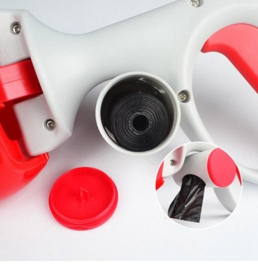 Dog waste scooper with red lid and white body, showing black bag inside.