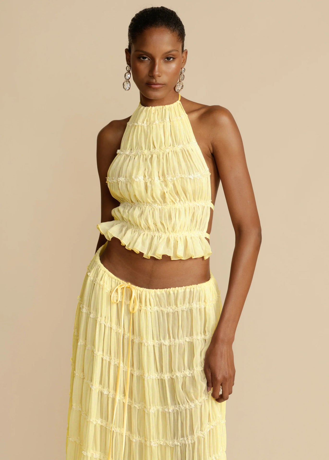 Yellow halter crop top and pleated long skirt set with tiered ruffles and elastic waist