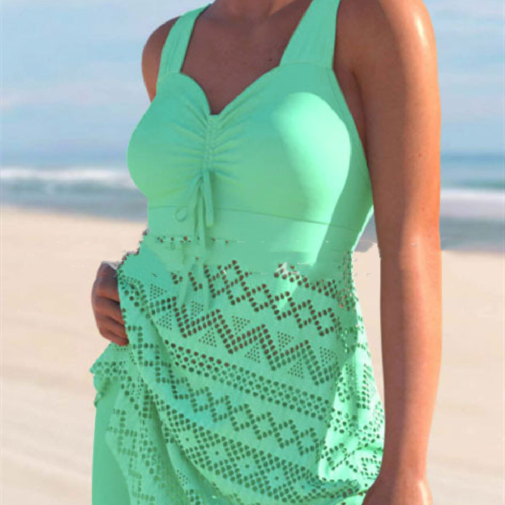 Mint green one-piece swimsuit with ruched chest pad and lace-patterned skirt overlay