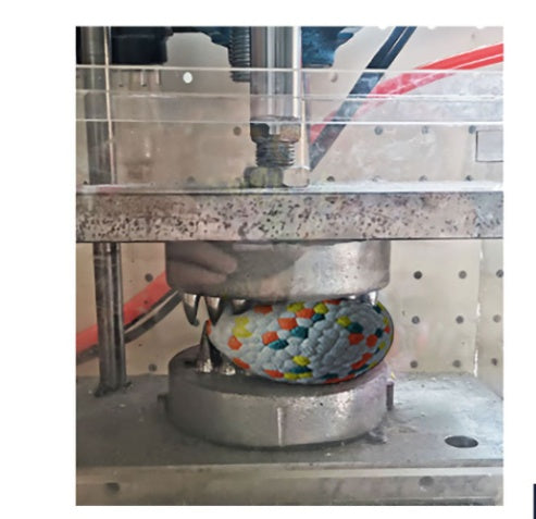 Textured dog chew ball in a metal molding machine