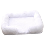 White plush dog bed with padded sides and rounded bolster base