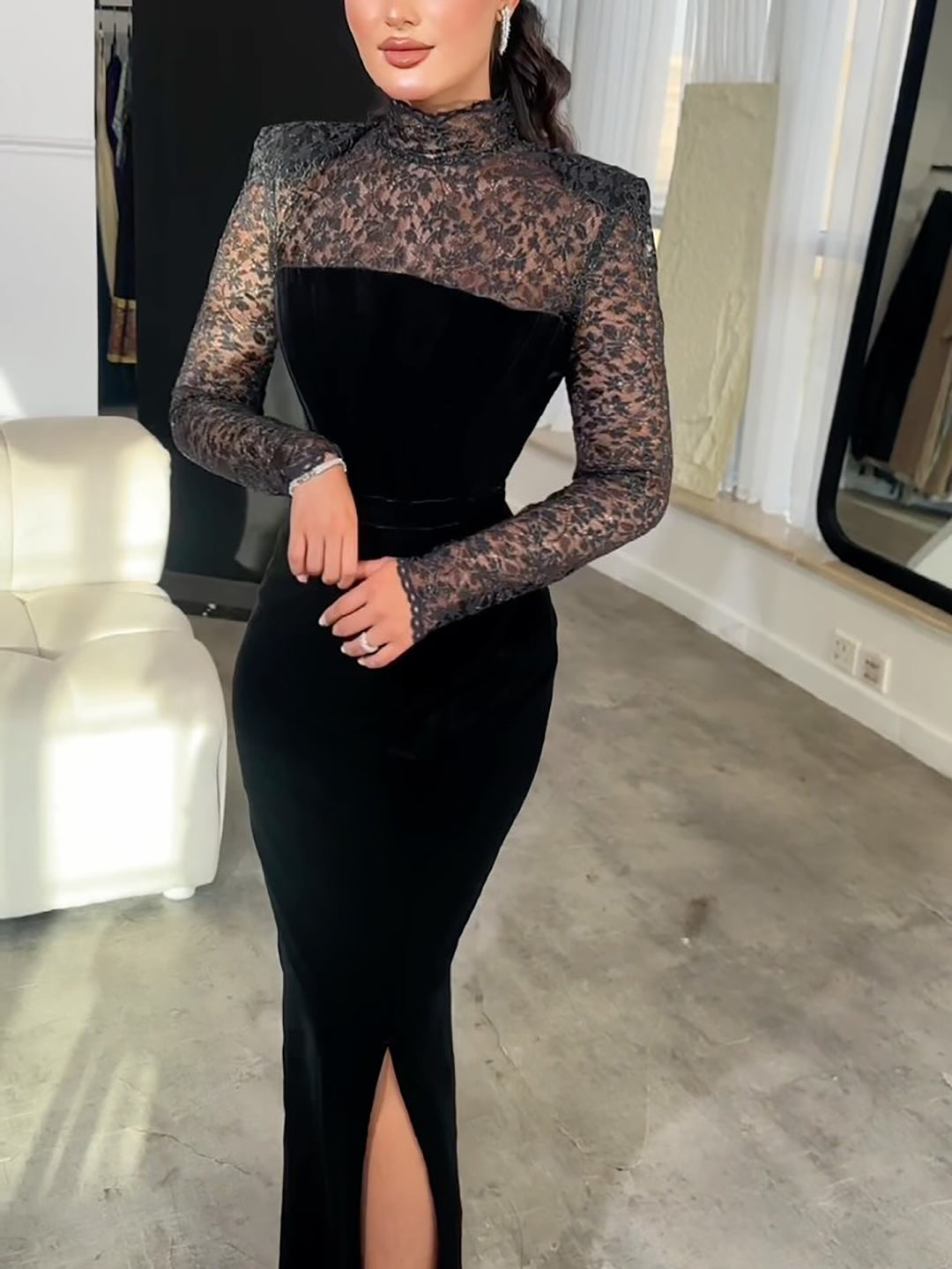 Black bodycon maxi dress with long lace sleeves, high neck, and front slit
