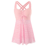 Light pink one-piece swimsuit with crisscross back straps and lace overlay skirt