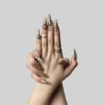 Almond press-on nails with gold and crystal rhinestone sparkle, shown on hands