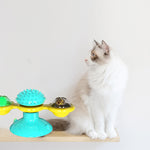 Cat rotating windmill toy with turquoise spiky top and yellow and clear rotating bowls
