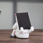 Astronaut resin phone stand showing side view with tilted phone support
