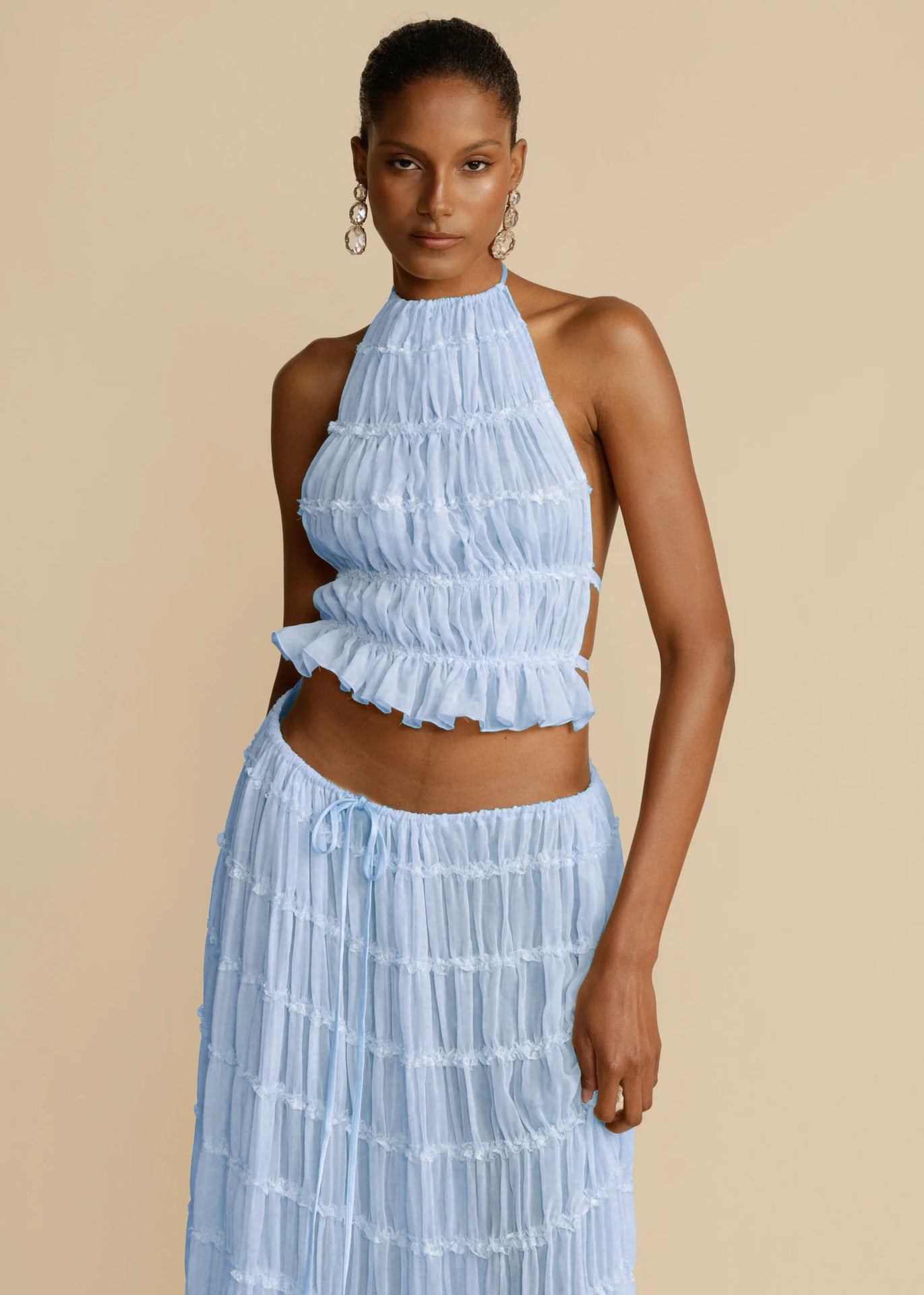 Light blue halter crop top and tiered pleated maxi skirt set with ruffled edges