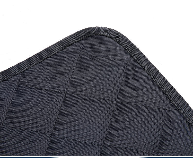 Black dog car seat cover corner with textured quilted fabric and stitched border trim