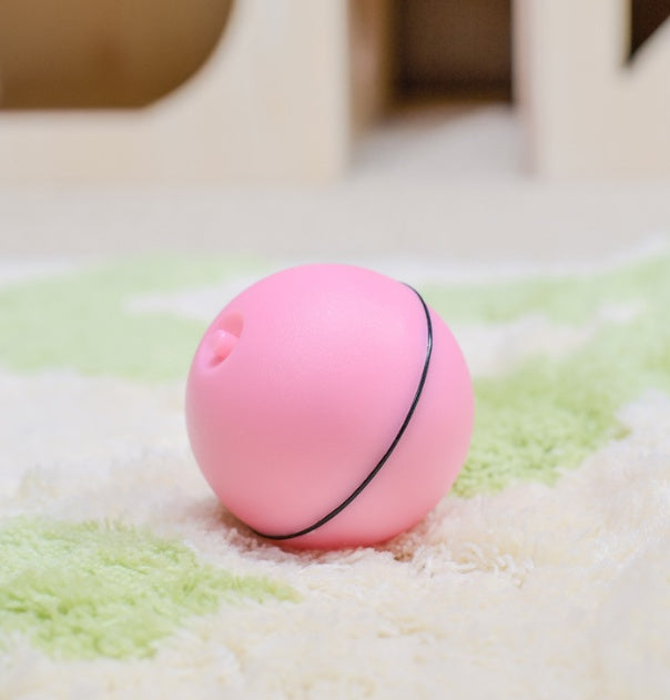 Pink LED rolling cat toy ball on a soft surface