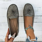 Women’s gray suede loafers with round toe, lace bow detail, stitched flat sole