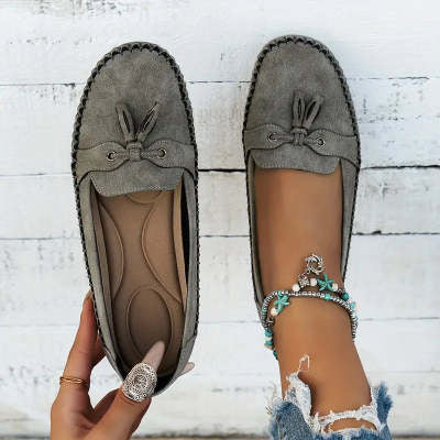 Women’s gray suede loafers with round toe, lace bow detail, stitched flat sole