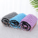 Three pet microfiber bath towels on a rack: black, blue, and purple with paw trims