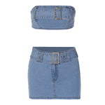 Blue denim tube top and mini skirt, both with buckle belt and stud details