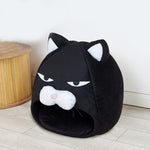 Black cat-face pet bed nest with hood opening and plush cushioned interior